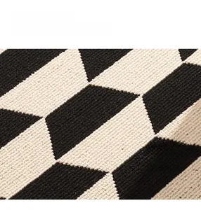 Close-up of double-layer woven loop pile rug with black and white geometric pattern