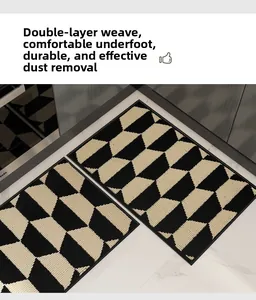 Close-up of double-layered woven floor mats with black and white 3D geometric patterns