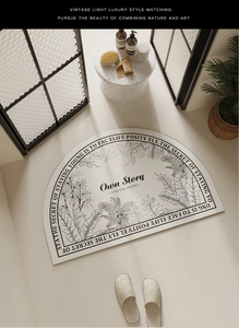 Semi-circle bath mat with tropical leaf pattern and 'Own Story' text in cream color
