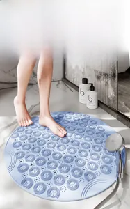 Macro shot of light blue silicone foot scrubber mat with soft massage bristles in a bathroom