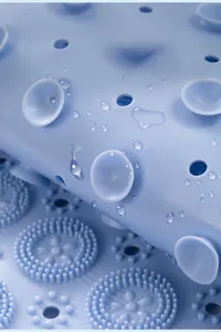 Macro view of blue silicone shower mat with suction cups and massage bristles