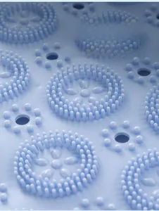 Macro detail of blue silicone bath mat showing dense round bristles and drainage holes
