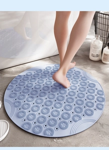 Macro detail of blue round non-slip shower mat with massage texture and drainage holes