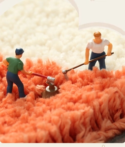 Macro shot of thick high-pile shaggy rug fibers in cream and coral orange texture