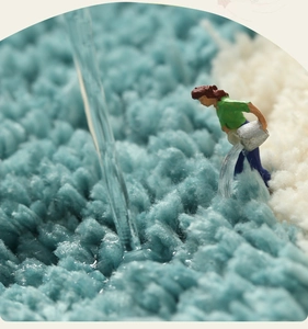 Macro shot of high-density blue and beige microfiber rug showing absorbent plush texture