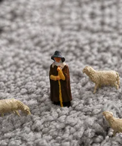 Close-up of thick grey plush bathroom rug with soft tufted flocking and miniature figures