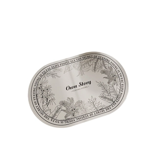 Oval diatom mud bath mat with tropical leaf art and 'Own Story' text on white background