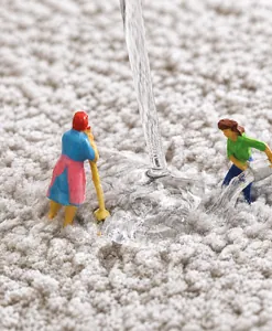 Macro view of light grey fluffy bath mat fibers showing absorbent quick-dry texture