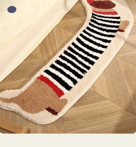 Detail of dachshund-shaped tufted rug showing plush texture and striped pattern on wood floor