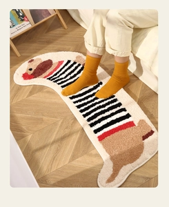 Thick flocked dachshund dog rug with striped pattern on light wooden floor texture