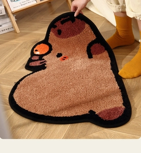 Close-up of thick Capybara shaped bath mat with high-density plush texture on wood floor