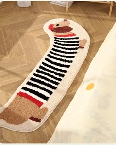 Detail of dachshund-shaped plush rug showing soft textured fabric on wooden floor