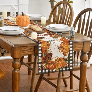 Macro shot of rustic Thanksgiving table runner with pumpkin and autumn leaf patterns
