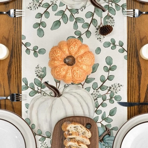 Detailed view of linen table runner featuring pumpkin and maple leaf harvest prints
