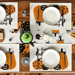 Close-up of autumn table runner set with happy fall pumpkin print on rustic wood table
