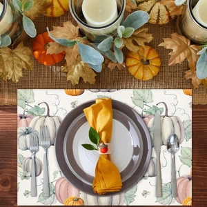Detail showing watercolor pumpkin and maple leaf print on a seasonal autumn placemat