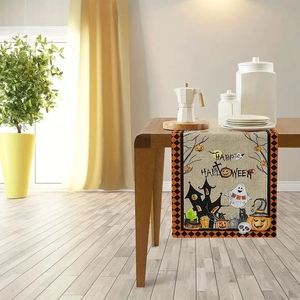 Detail of Halloween table runner featuring ghost and pumpkin prints on burlap fabric