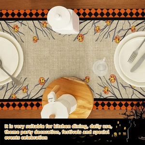Detail of Halloween table runner with pumpkin patterns and orange-black plaid edges