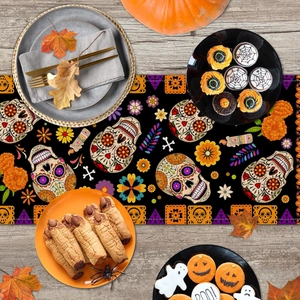 Macro view of Day of the Dead table runner with sugar skull prints on wood surface