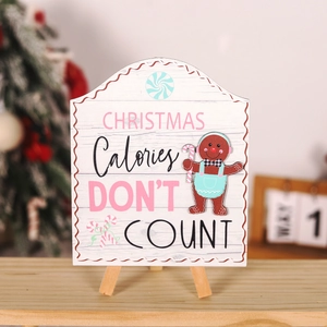 Detail of wooden Christmas gingerbread man sign with Christmas Calories Don't Count text