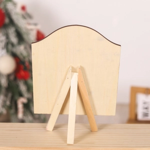 Detail view of the wooden gingerbread man sign showing its natural wood back and tripod stand