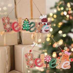 Close-up of wooden Believe pendants with gingerbread men and candy canes for Christmas trees