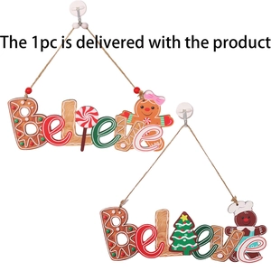 Macro view of Christmas wooden hanging pendant with Believe text and gingerbread man