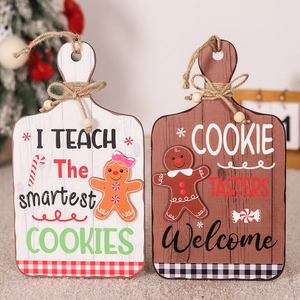 Detail of wooden gingerbread door signs with I TEACH and COOKIE TASTERS slogans
