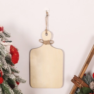 DIY gingerbread house wood sign hanging with burlap bow in a festive Christmas scene