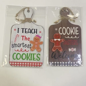 Close-up of wooden gingerbread man welcome signs in transparent plastic packaging
