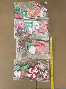 Close-up of wooden Christmas gnome and gingerbread ornaments with size measuring tape