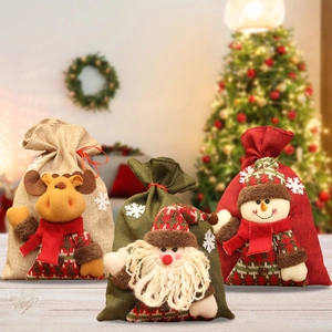 Detail of Christmas burlap gift bags featuring 3D plush reindeer, Santa, and snowman designs