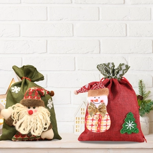 Detail of Christmas burlap gift bags featuring 3D Santa Claus and snowman dolls