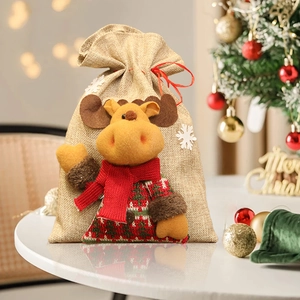 Christmas burlap drawstring gift bag featuring a 3D plush reindeer with festive bokeh lights