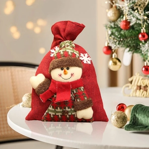 Detailed view of red burlap Christmas drawstring bag featuring a 3D plush snowman design