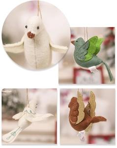 Detail of handmade felt bird ornaments with decorative stitching and rustic jute twine