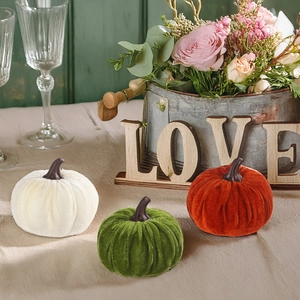 Three velvet decorative pumpkins in cream, green and rust orange for autumn decor