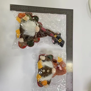 Detail view of plush Thanksgiving gnomes featuring turkey feathers and pumpkin elements