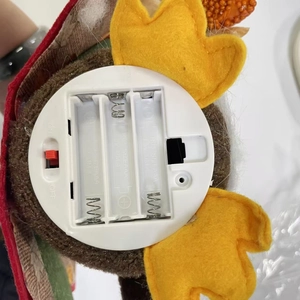 Detail view of the battery compartment for Harvest Festival gnome with ON/OFF switch