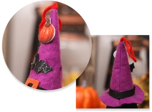 Detail showing a purple felt witch hat decoration with pumpkin patch and bat elements