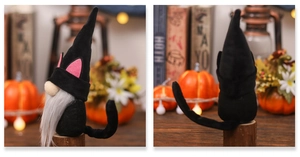 Detail of Halloween black cat gnome plush with pointed hat and pink ears decoration