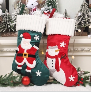 Detail of Christmas stocking set with Santa and Snowman embroidery and plush white cuffs