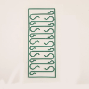 Green plastic S-shaped hooks for Christmas ornaments and festive decorations