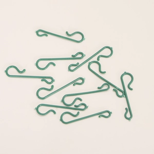 Green S-shaped plastic hooks for Christmas ornaments and festive light decorations