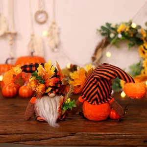 Harvest festival gnomes with maple leaf and pumpkin decorations for autumn home decor