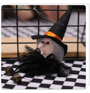 Detail of Halloween witch hanging decor with lace skirt, pointed hat and copper bells