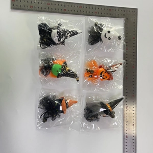 Detailed close-up of six Halloween plush pendants including ghosts, pumpkins, and witches