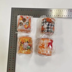 Close-up of four assorted autumn themed ribbons with pumpkins and maple leaves patterns