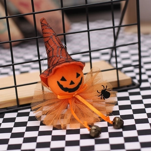Halloween pumpkin witch pendant with orange mesh collar and bronze bells on metal rack
