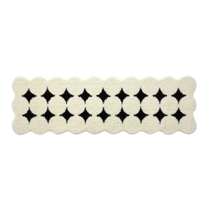 Creamy white plush runner rug with black star patterns and unique scalloped edges